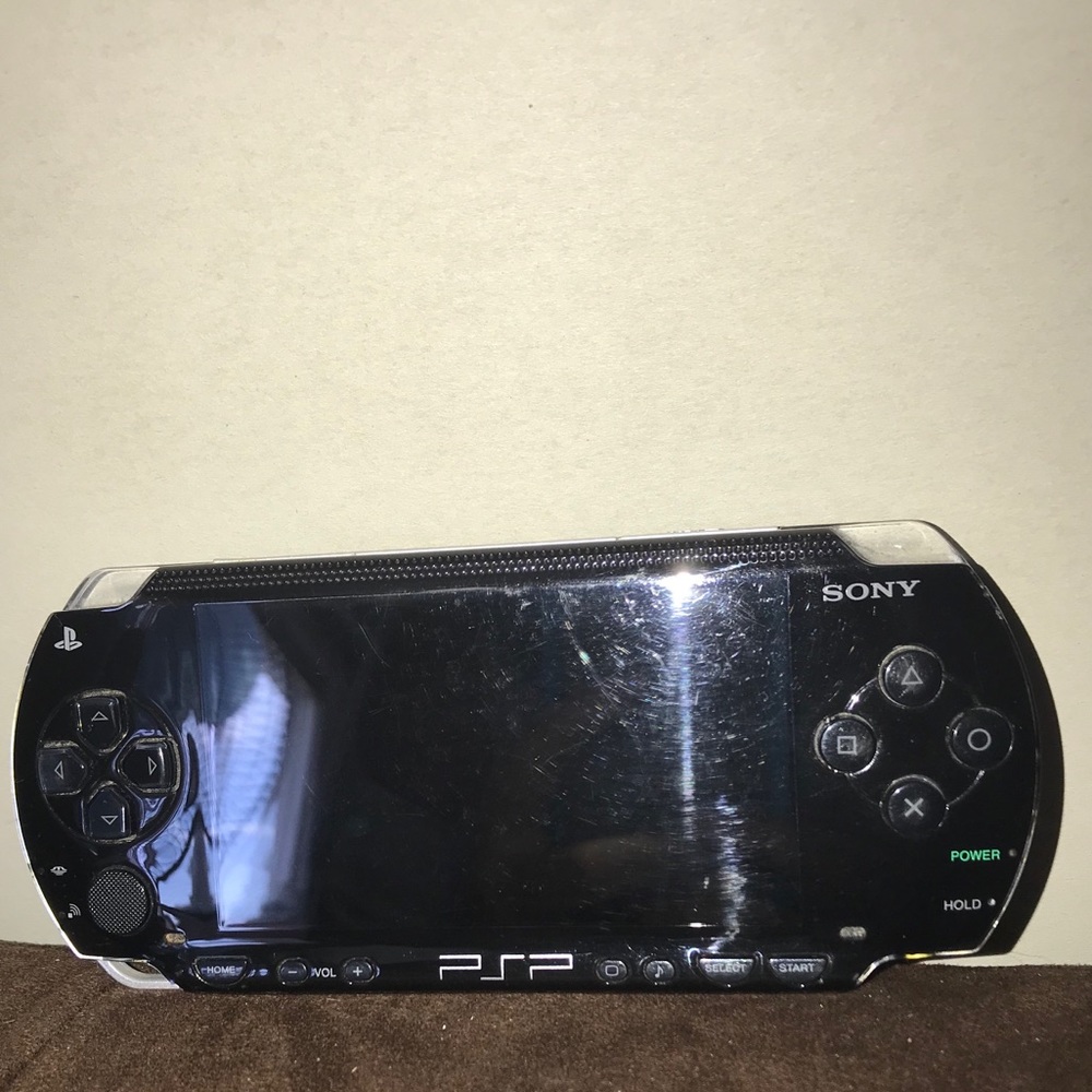 PlayStation Portable (PSP) with charger